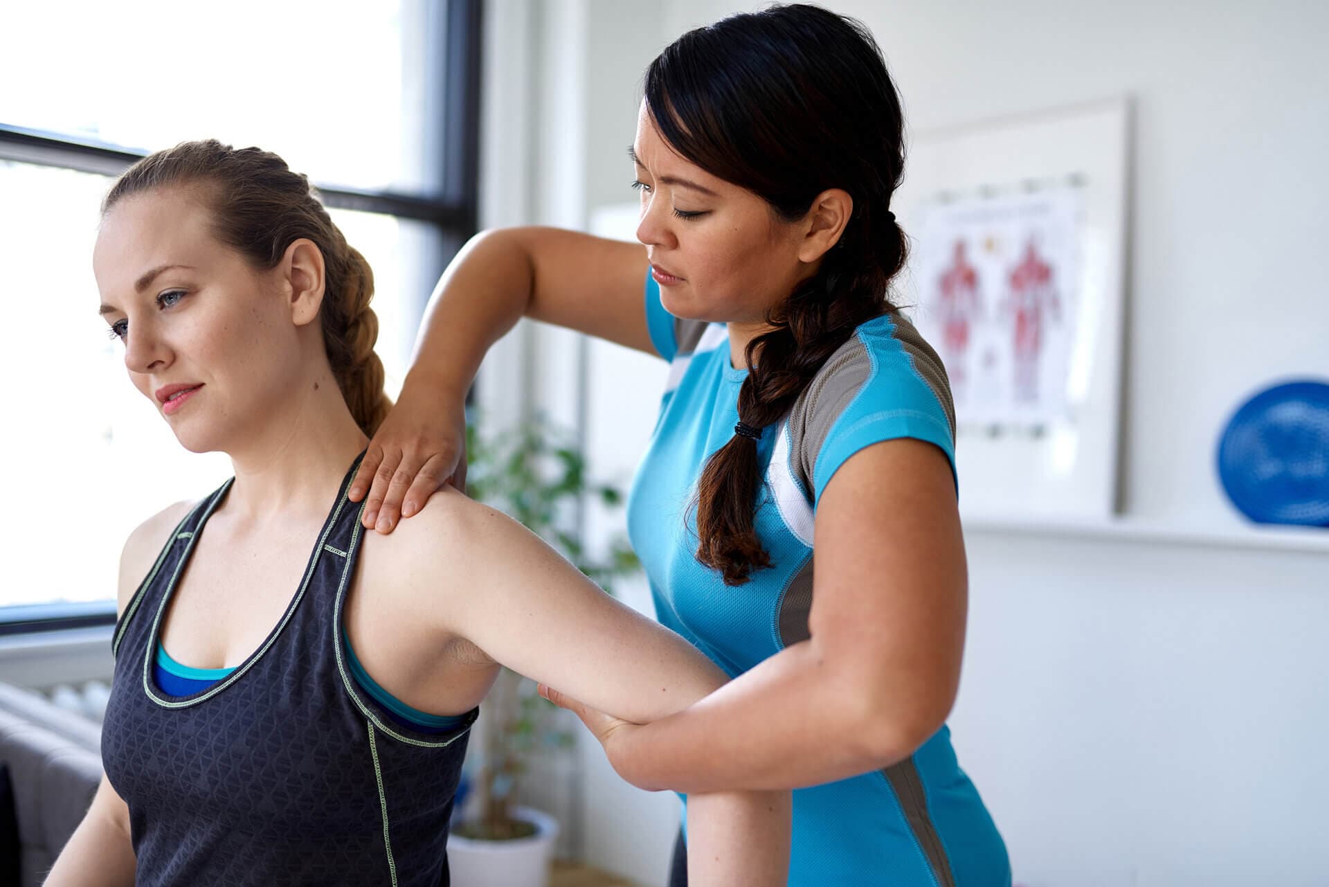 physio assisting with shoulder pain