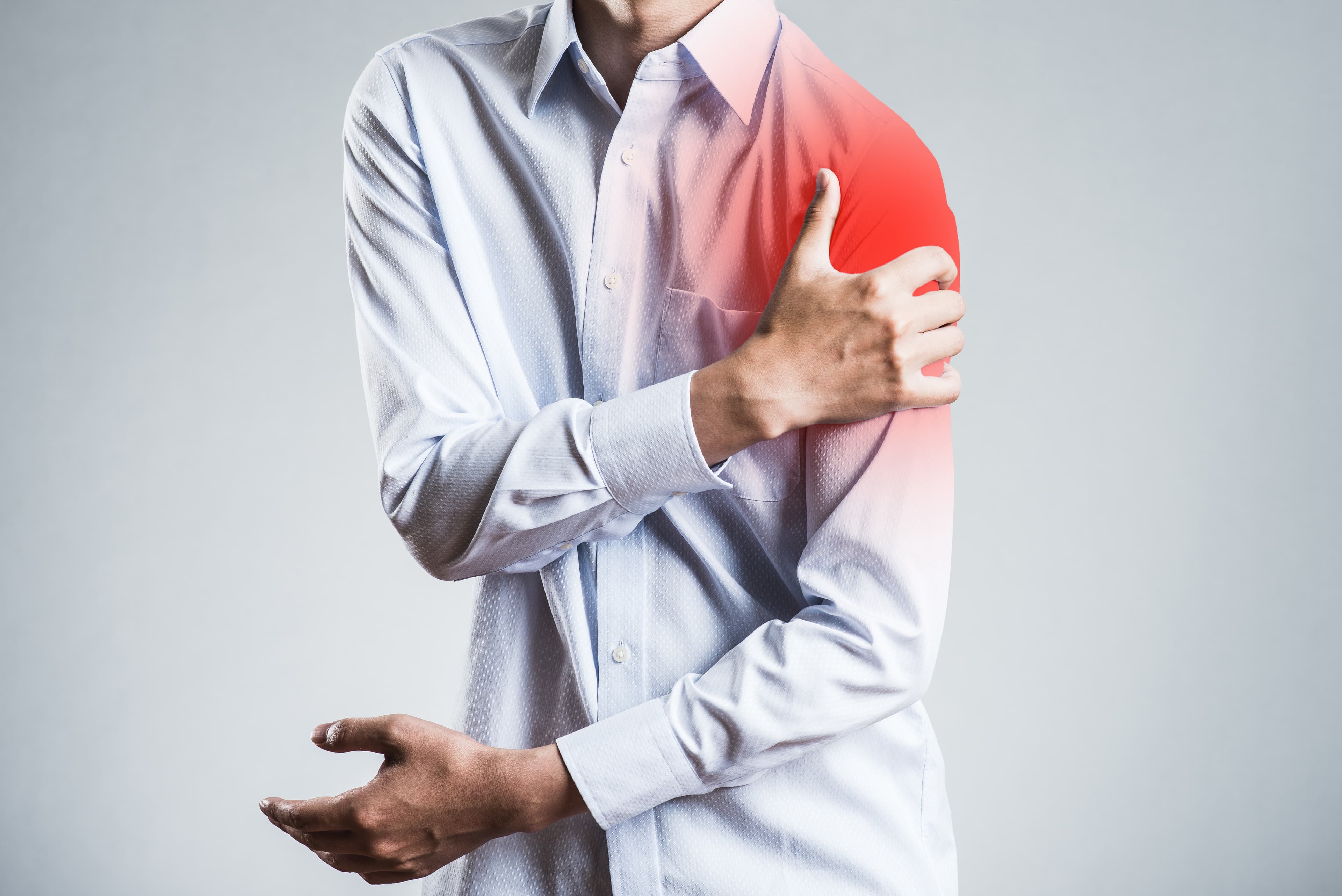 holding shoulder in pain