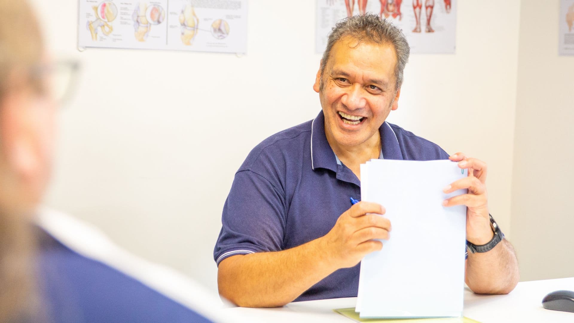 Person smiling happily in a physiotherapy clinic