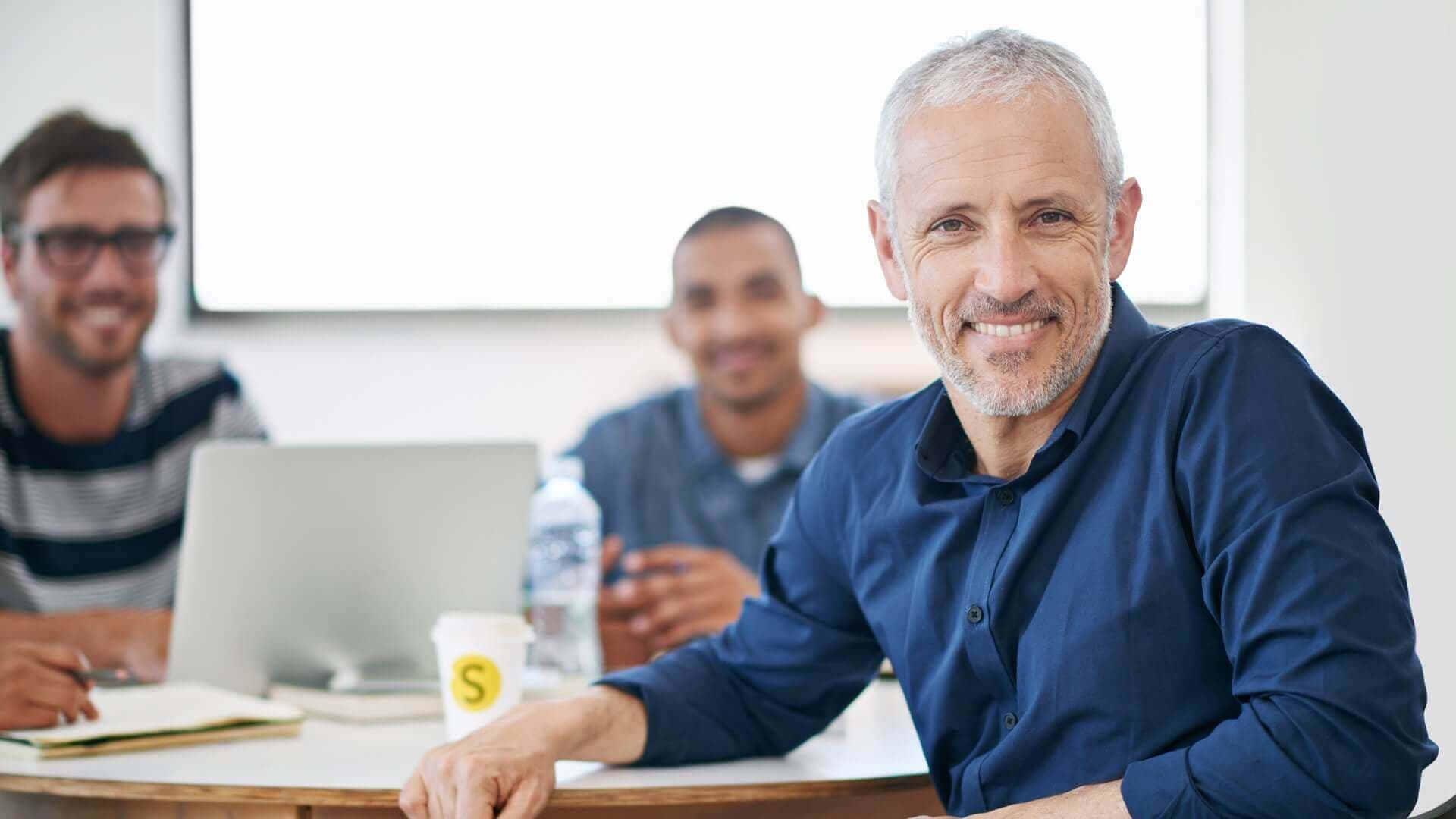 group in a meeting smiling