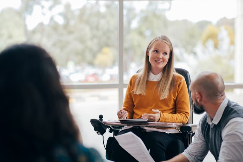 Woman in a wheelchair speaking to a group