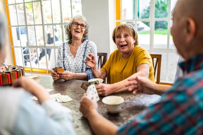 Group of senior people laughing around a table
