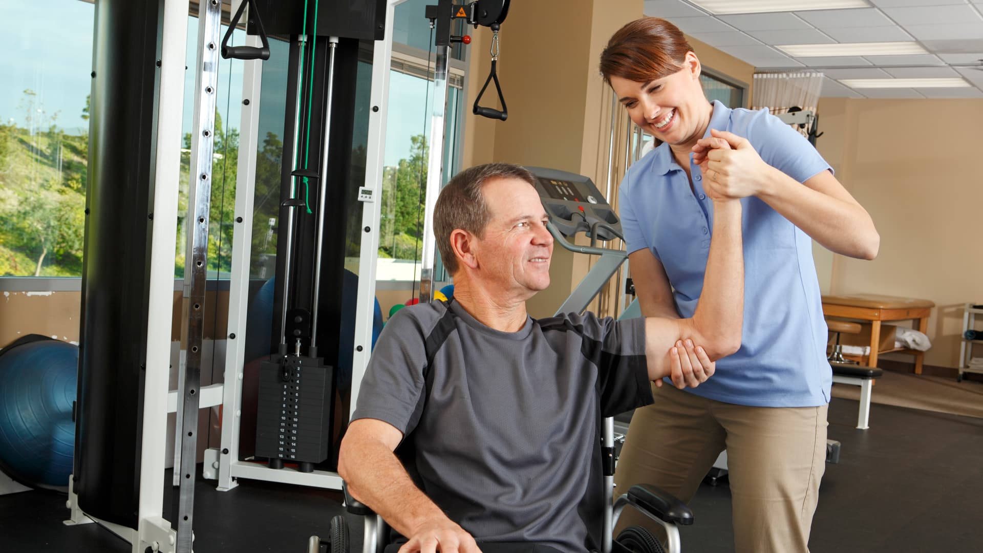 Physio helping patient test shoulder mobility